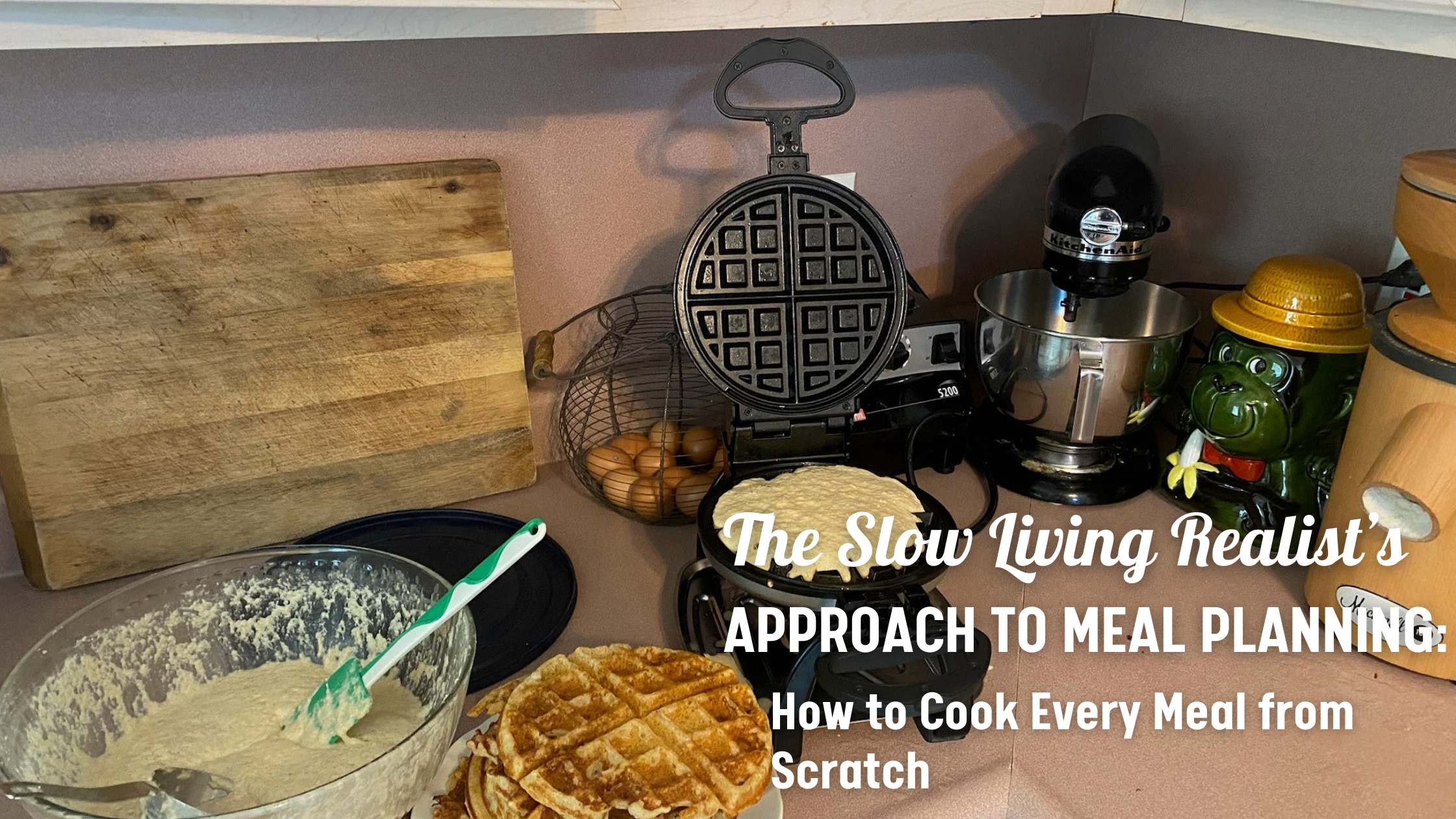 Picture of a batch of waffles being made with a grain mill and kitchen aid mixer in the background. Meal planning and slow living.